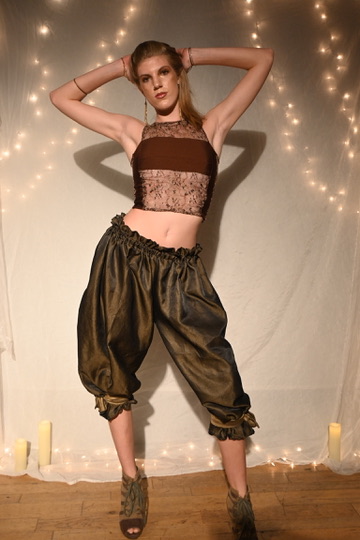 Model in a textured crop top and metallic bronze harem pants, ENNA runway show