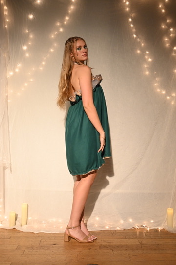 Model in an emerald satin babydoll dress with a sequin bodice, back view, ENNA runway show